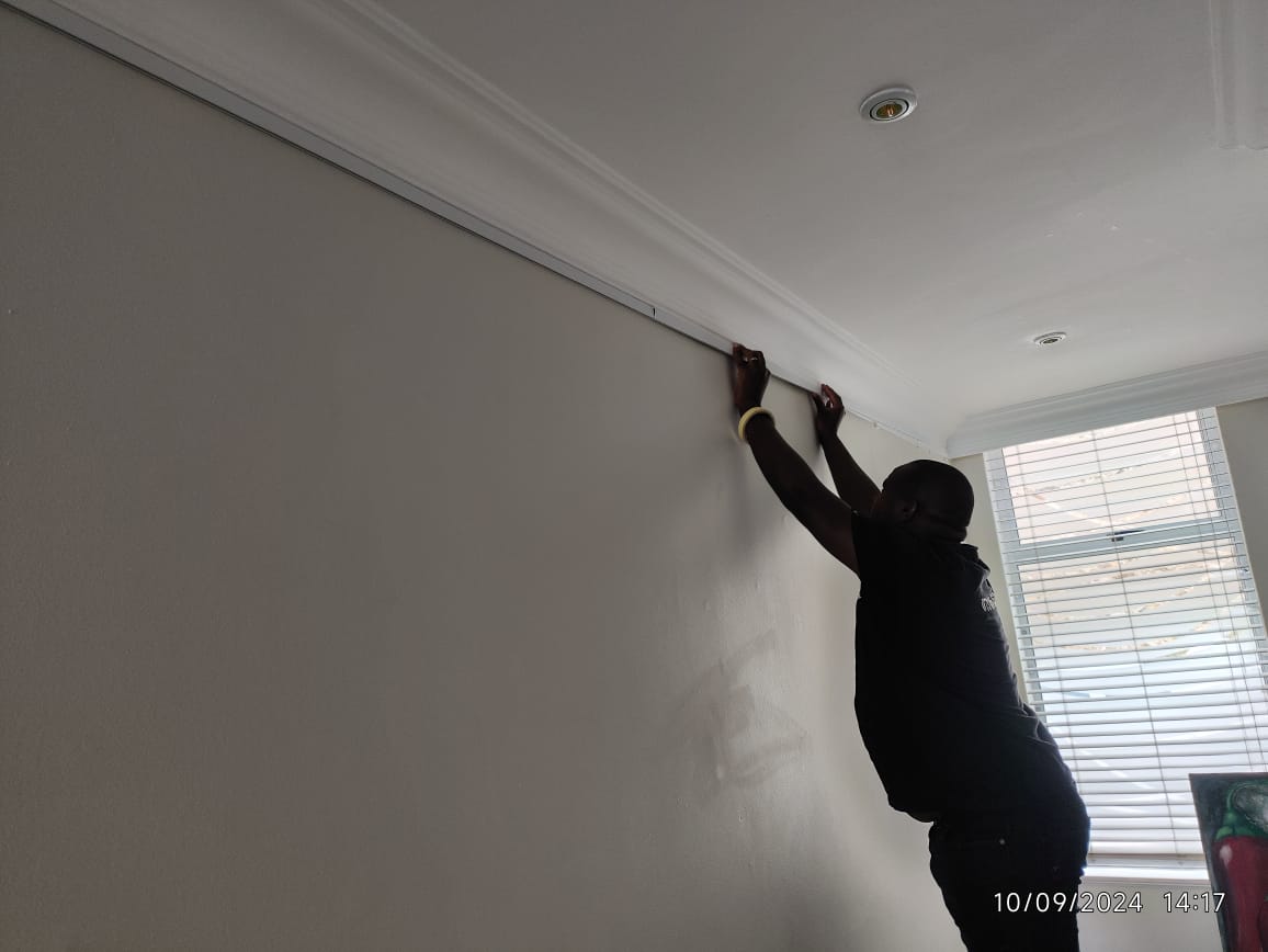 Gift installing a picture rail neatly below the ceiling line